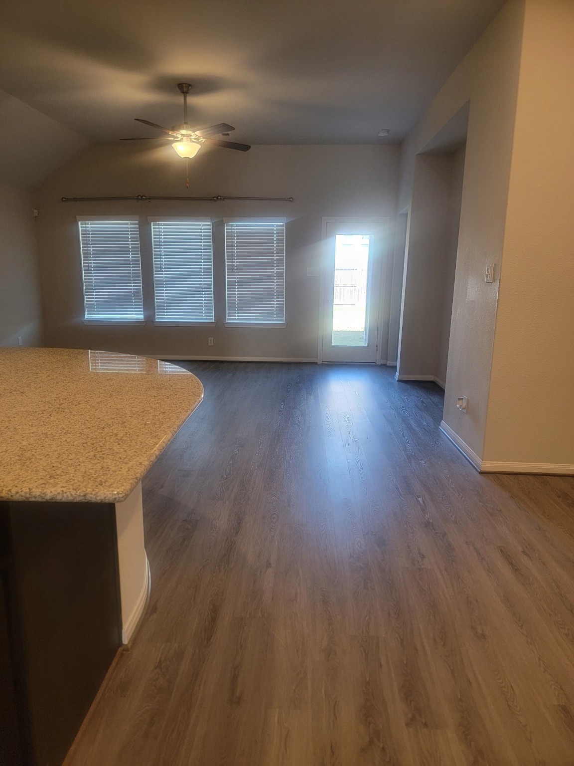 1406 Munson Valley Road Richmond, TX 77406 - Photo 7 of 27 an empty room with wooden floor and windows