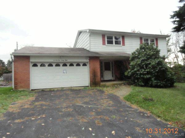 7198 Heather Road Macungie, PA 18062 - Photo 1 of 1 a house that has a tree in front of the house