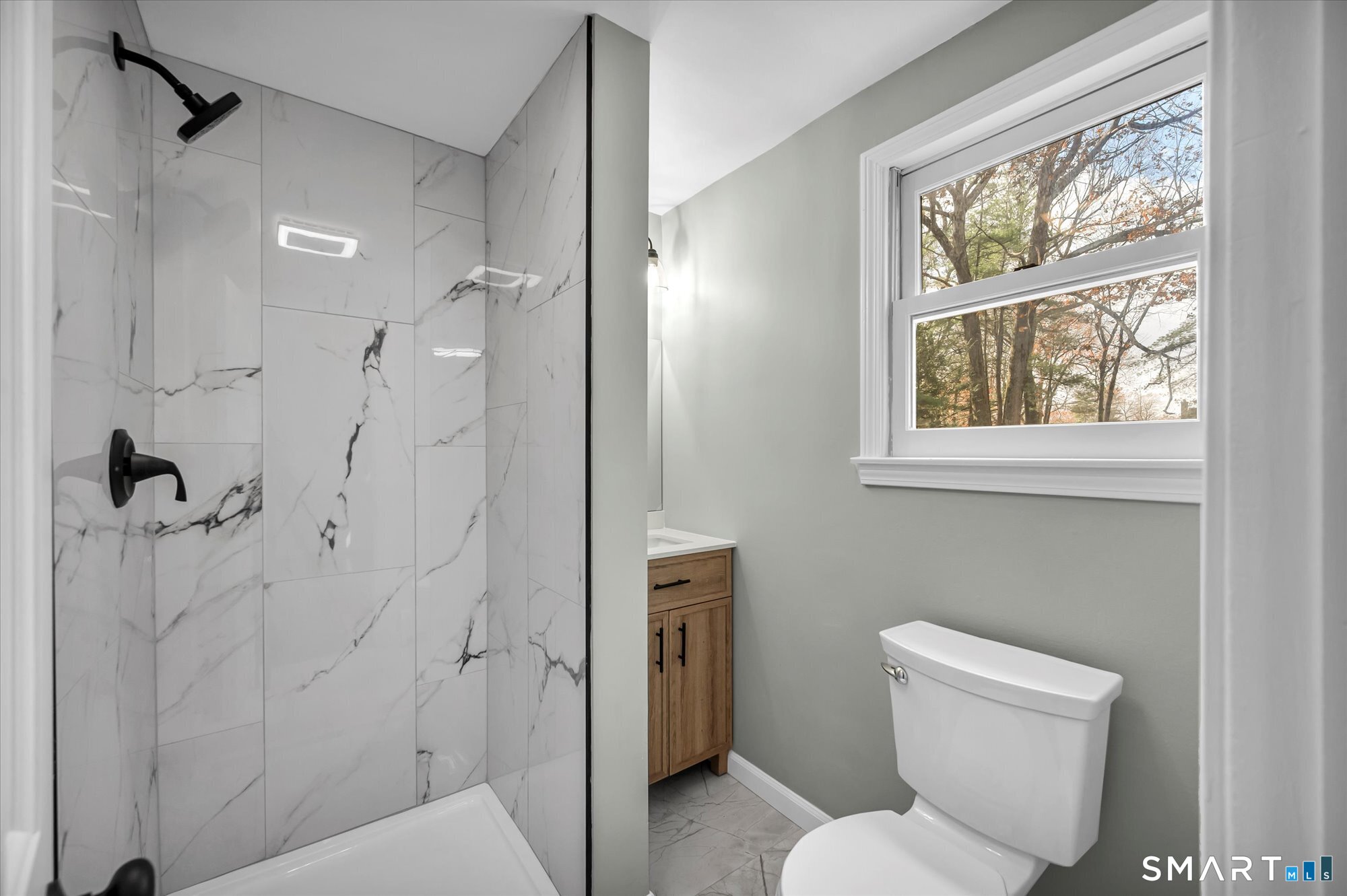 84 Raffia Road Enfield, CT 06082 - Photo 11 of 34 a bathroom with a toilet sink and shower