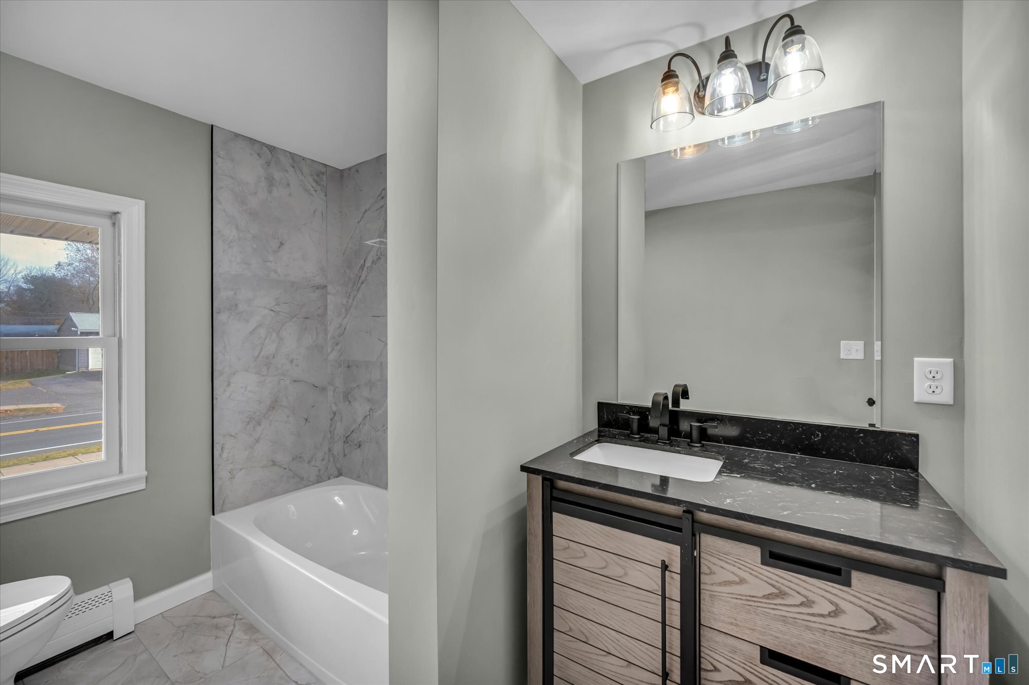 84 Raffia Road Enfield, CT 06082 - Photo 12 of 34 a bathroom with a sink and a mirror