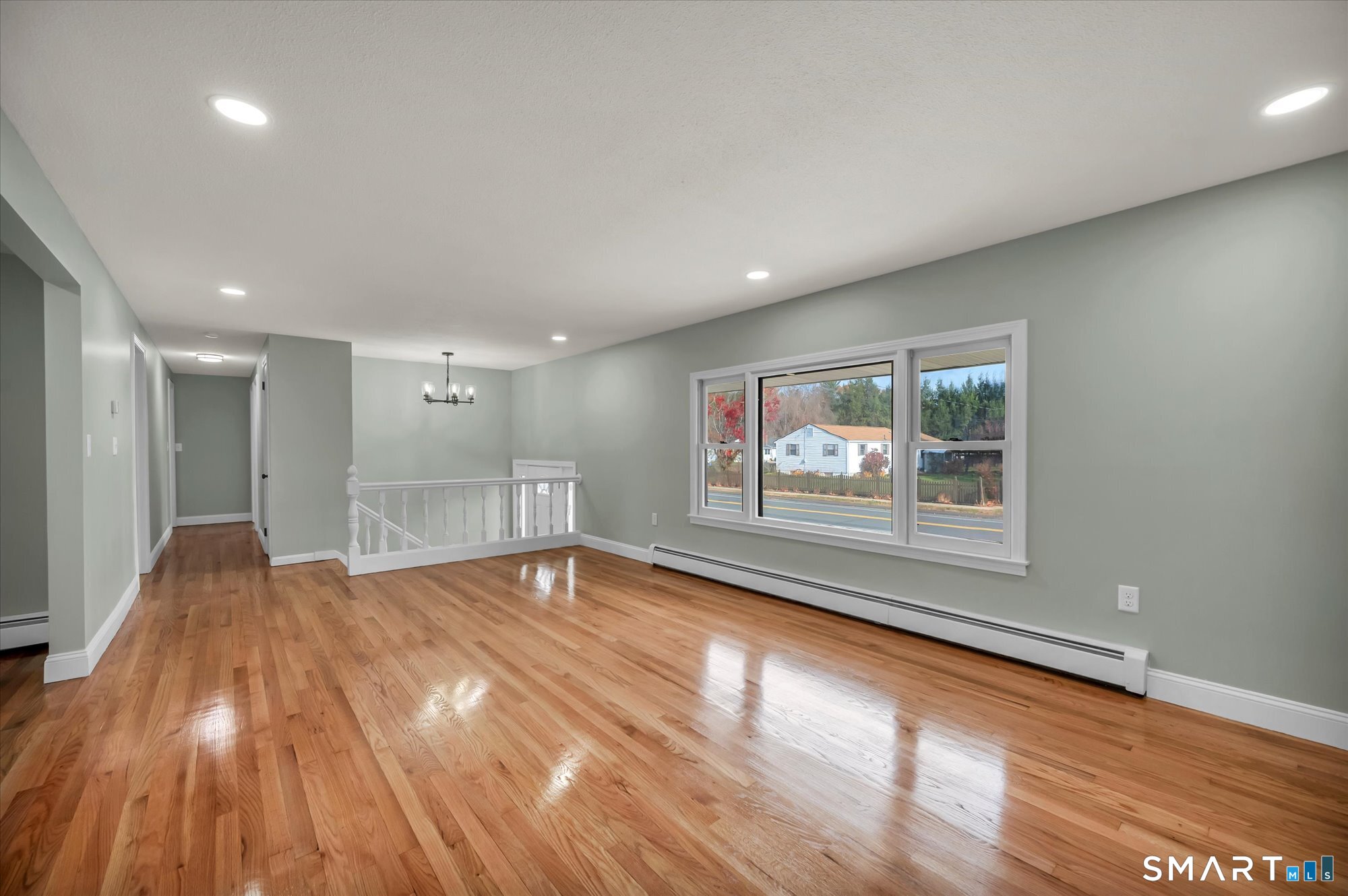 84 Raffia Road Enfield, CT 06082 - Photo 17 of 34 a view of an empty room with wooden floor and a window