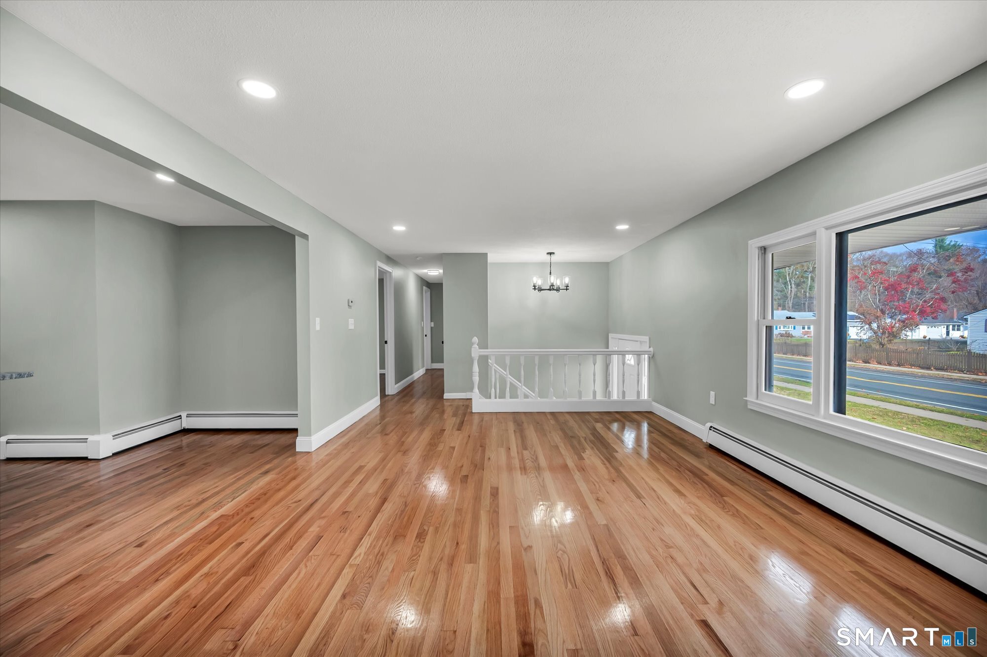 84 Raffia Road Enfield, CT 06082 - Photo 18 of 34 a view of an empty room with wooden floor and a window
