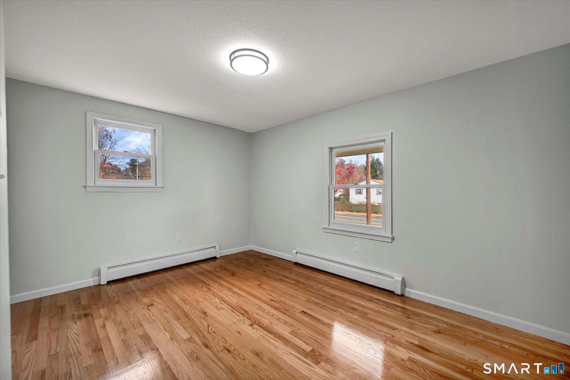 84 Raffia Road Enfield, CT 06082 - Photo 23 of 34 an empty room with wooden floor and windows