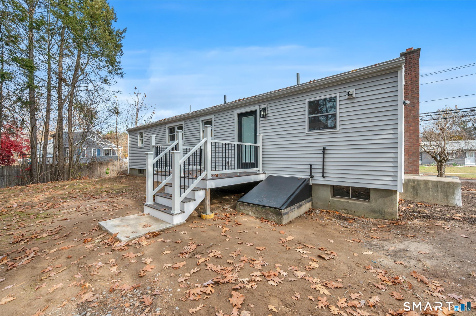 84 Raffia Road Enfield, CT 06082 - Photo 32 of 34 a view of a house with backyard and wooden fence
