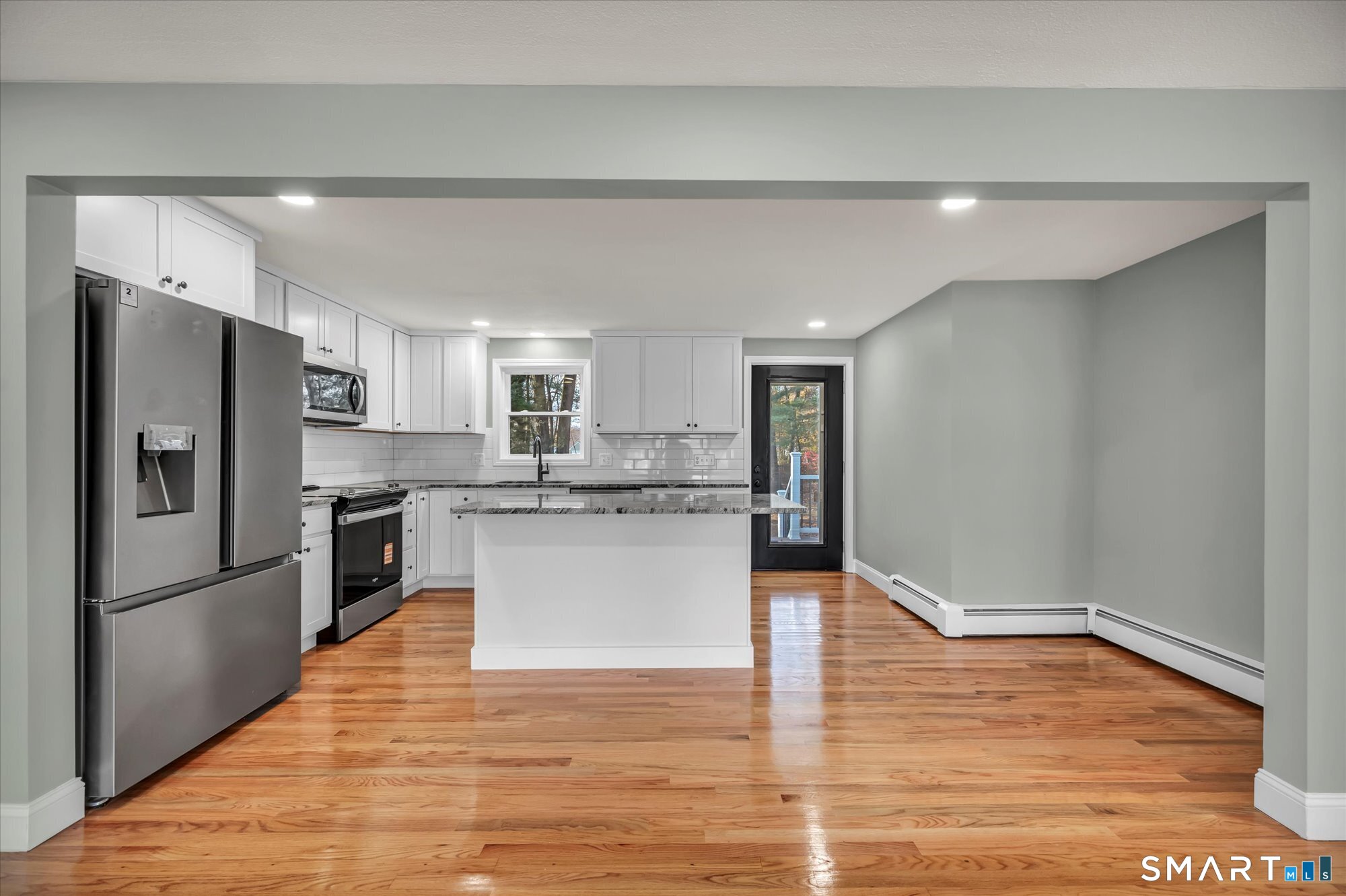 84 Raffia Road Enfield, CT 06082 - Photo 6 of 34 a kitchen with a refrigerator and white cabinets