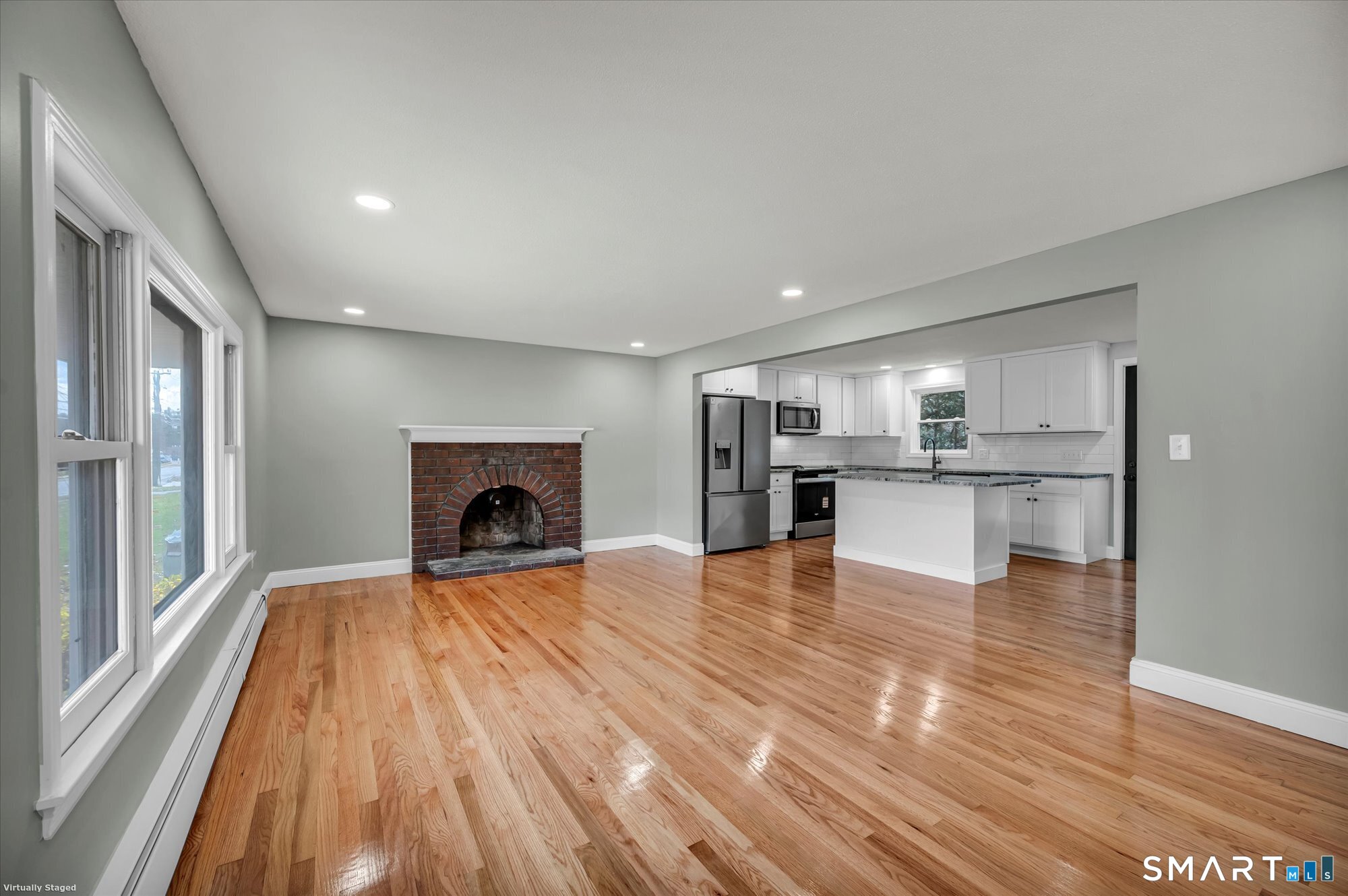 84 Raffia Road Enfield, CT 06082 - Photo 7 of 34 a view of empty room with wooden floor and fireplace