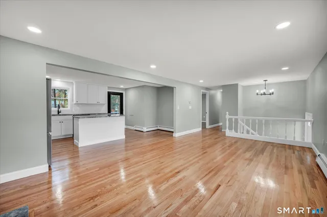 a view of a kitchen with wooden floor and a kitchen