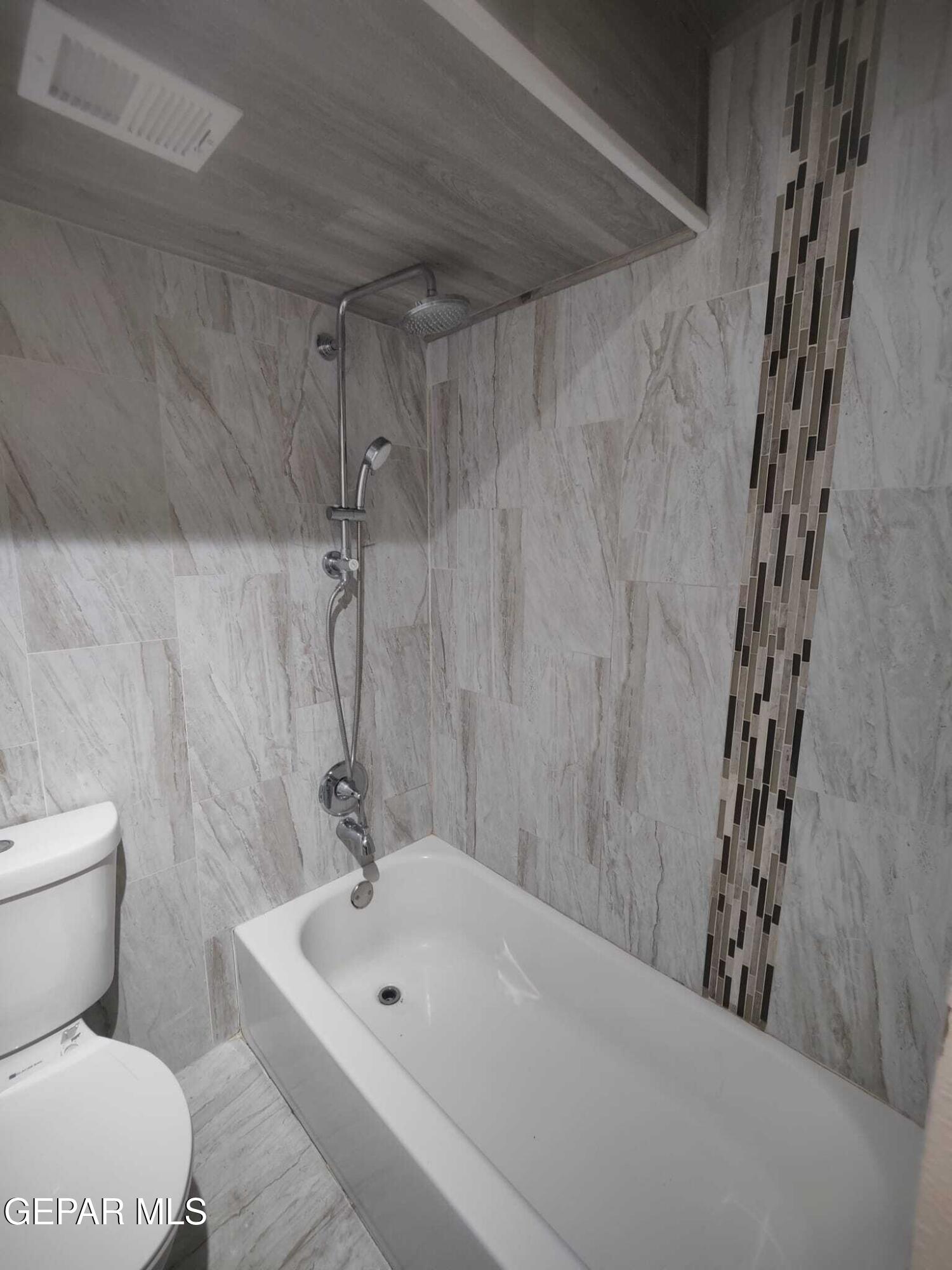 1639 Brian Ray Circle El Paso, TX 79936 - Photo 13 of 52 a bathroom with a white bath tub a toilet and a sink