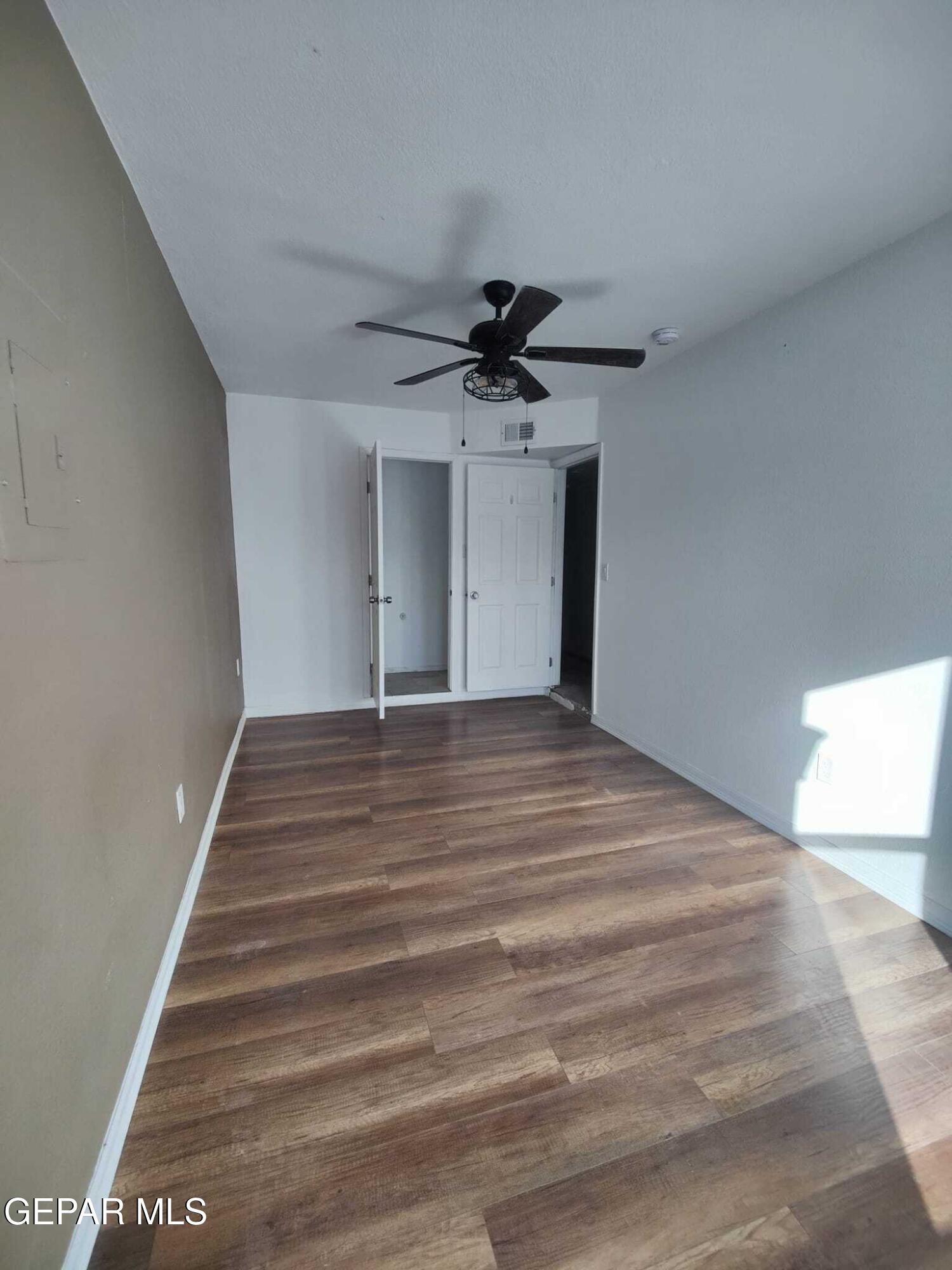 1639 Brian Ray Circle El Paso, TX 79936 - Photo 24 of 52 a view of empty room with wooden floor and fan