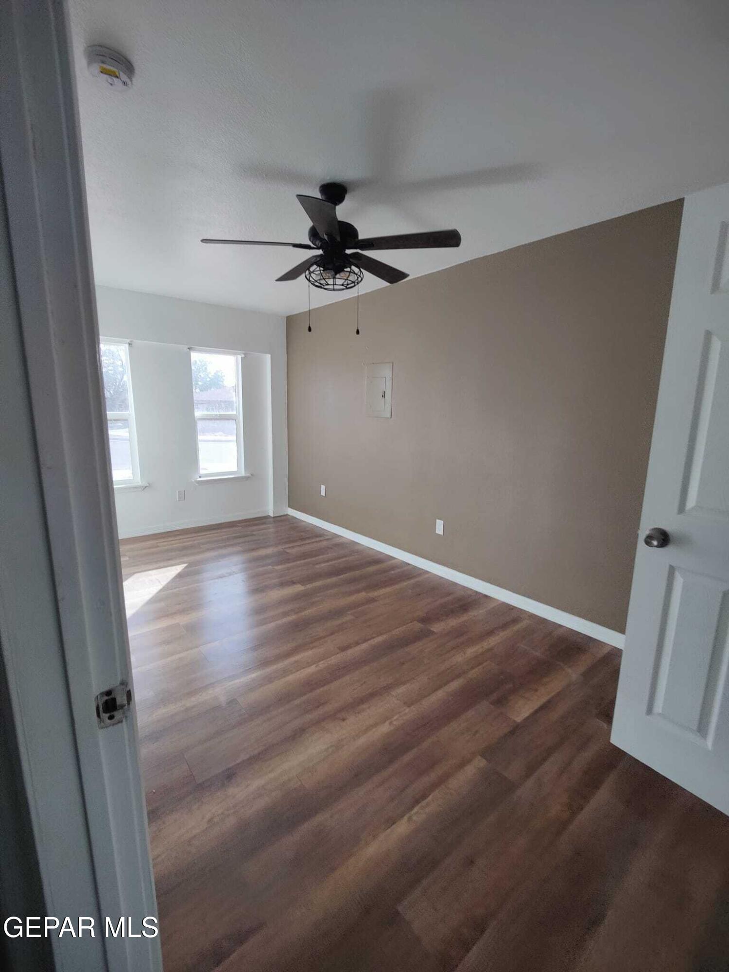 1639 Brian Ray Circle El Paso, TX 79936 - Photo 28 of 52 wooden floor in an empty room with a window