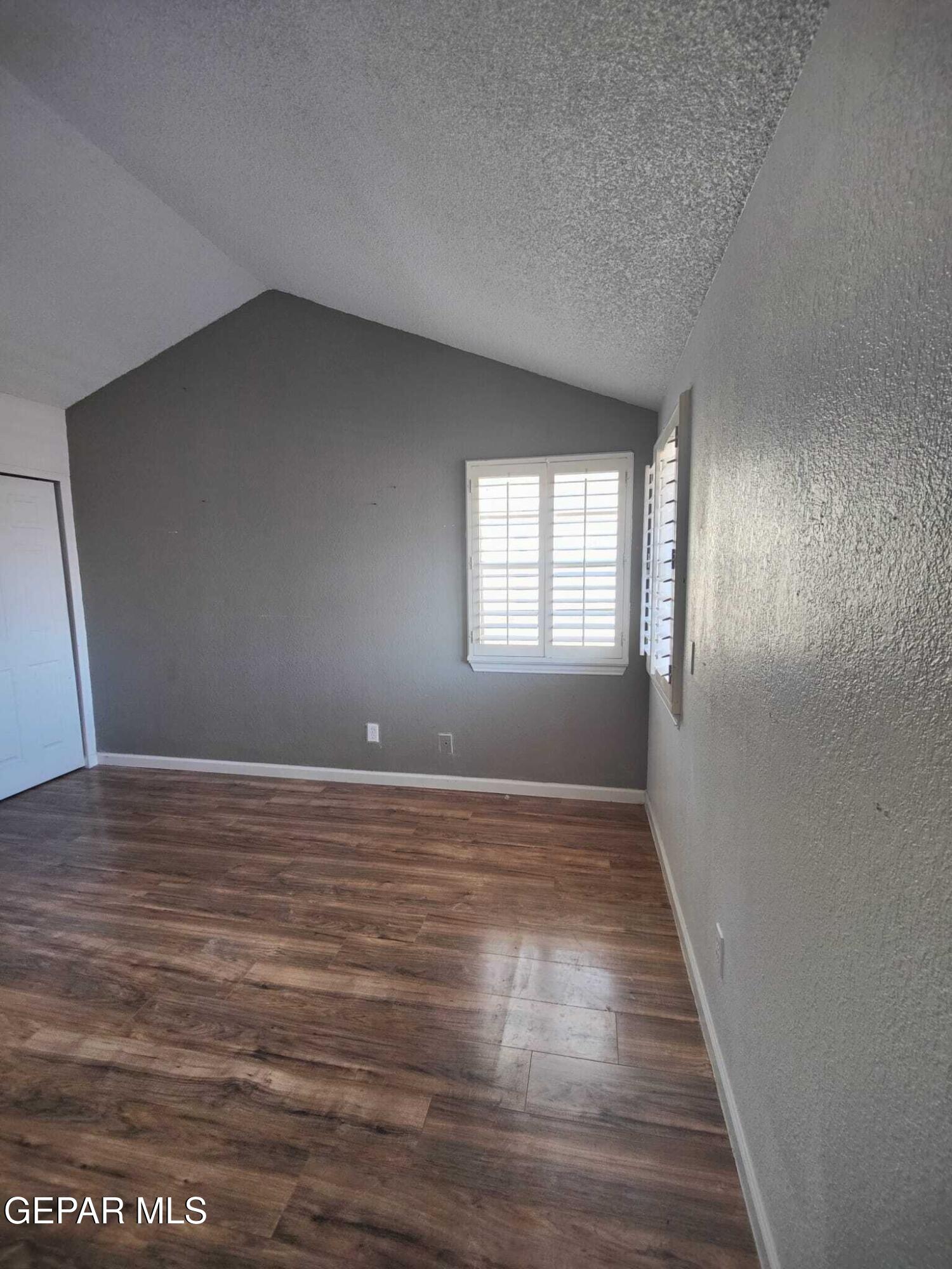 1639 Brian Ray Circle El Paso, TX 79936 - Photo 35 of 52 a view of an empty room with wooden floor and a window