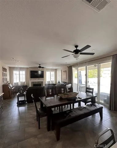 a living room with furniture a flat screen tv and a large window
