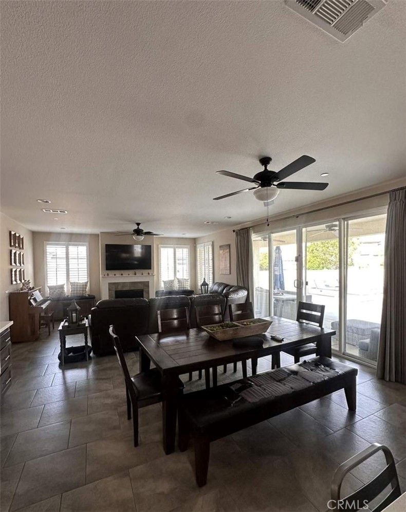 39552 Strada Scala Lake Elsinore, CA 92532 - Photo 11 of 40 a living room with furniture a flat screen tv and a large window