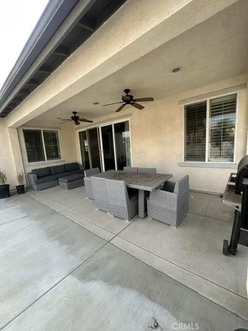 a view of a patio with table and chairs