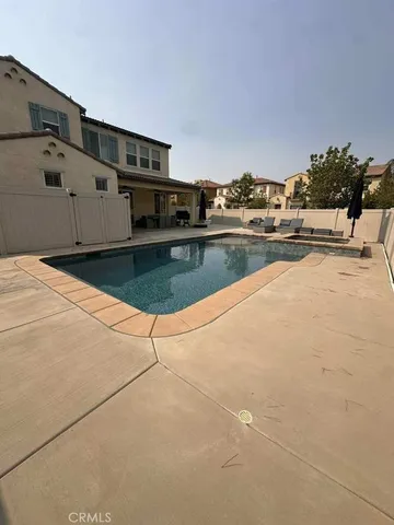 a view of a swimming pool with an outdoor seating