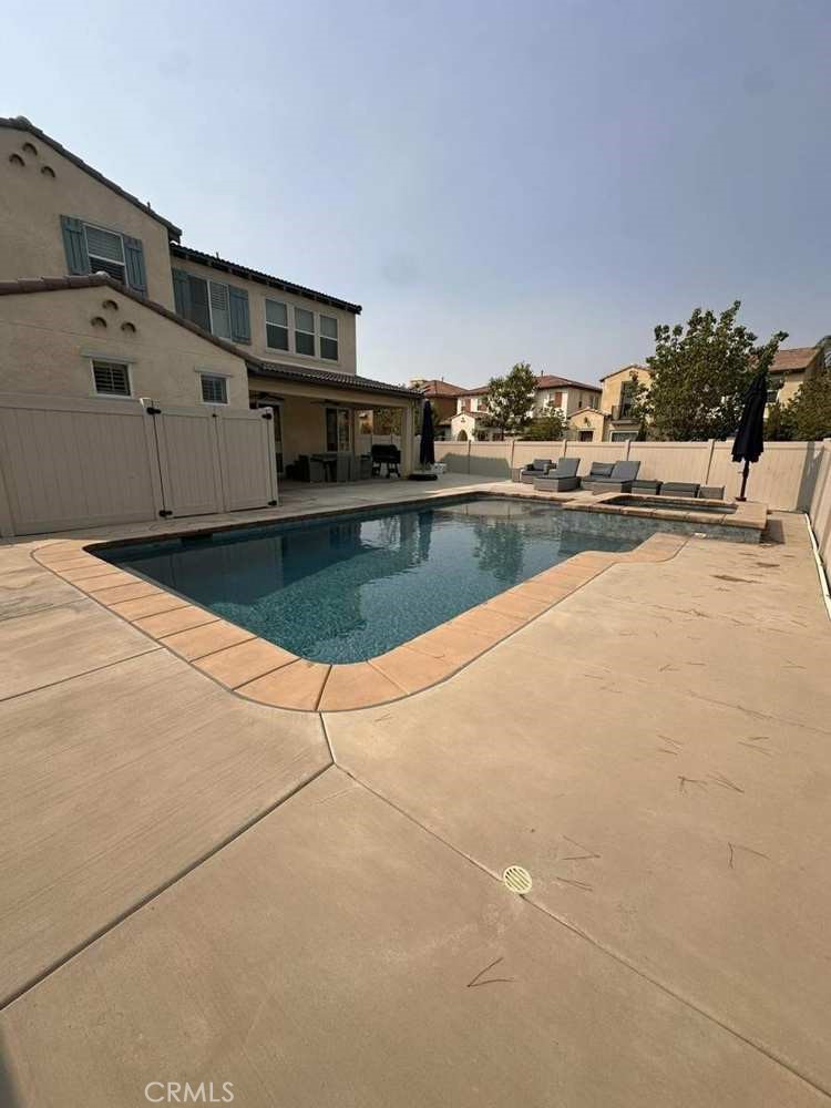 39552 Strada Scala Lake Elsinore, CA 92532 - Photo 18 of 40 a view of a swimming pool with an outdoor seating