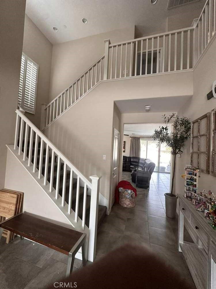 39552 Strada Scala Lake Elsinore, CA 92532 - Photo 21 of 40 a view of staircase with furniture and a chandelier