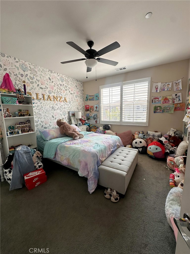 39552 Strada Scala Lake Elsinore, CA 92532 - Photo 28 of 40 a bedroom with bed couch and window