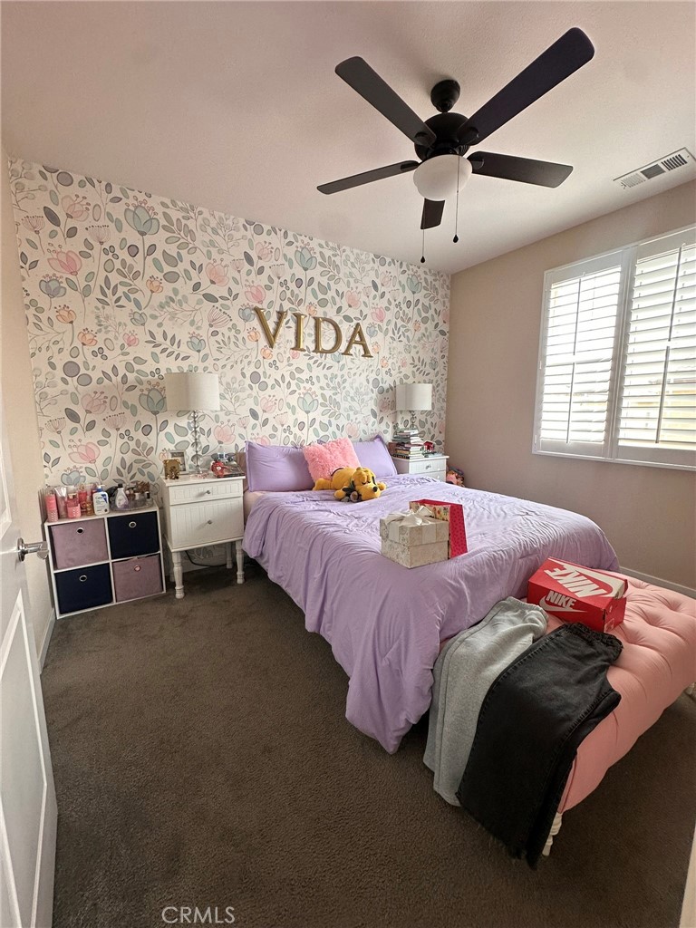 39552 Strada Scala Lake Elsinore, CA 92532 - Photo 29 of 40 a bedroom with bed and a chandelier
