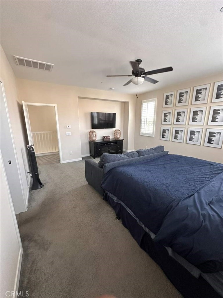 39552 Strada Scala Lake Elsinore, CA 92532 - Photo 31 of 40 a spacious bedroom with a bed window and flat screen tv