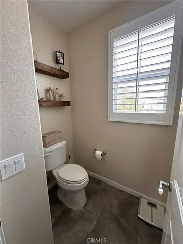 a bathroom with a toilet a sink and a window