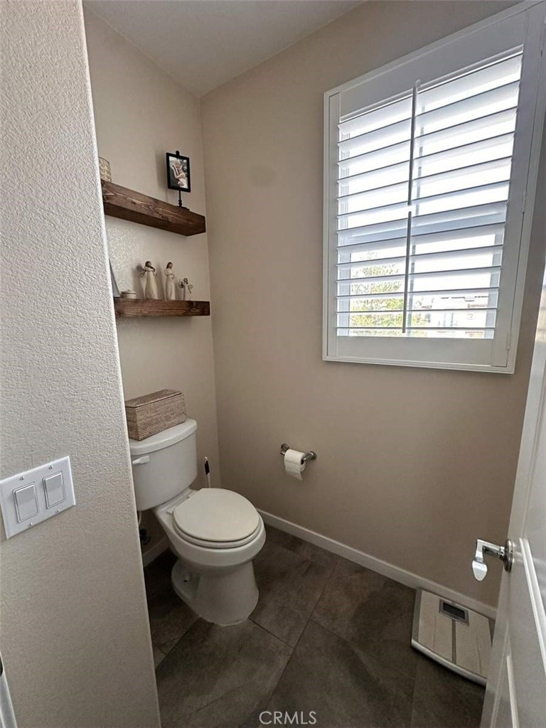 39552 Strada Scala Lake Elsinore, CA 92532 - Photo 33 of 40 a bathroom with a toilet a sink and a window