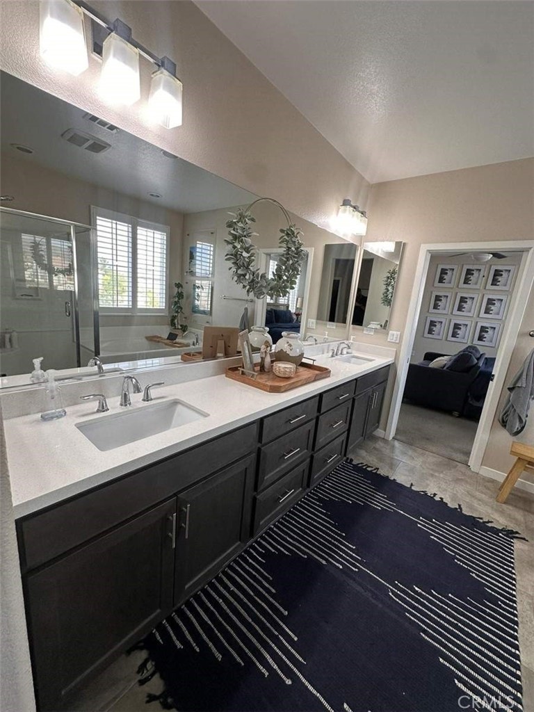 39552 Strada Scala Lake Elsinore, CA 92532 - Photo 34 of 40 a en suite bathroom with a double vanity sink and a mirror