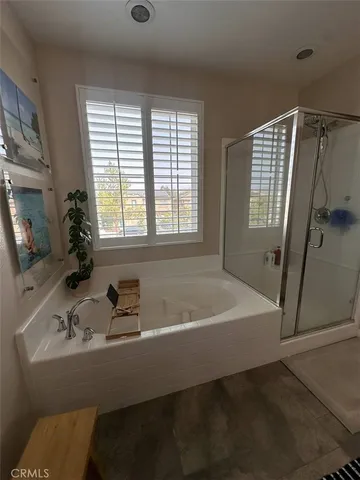 a bath tub sitting in a bathroom next to a window