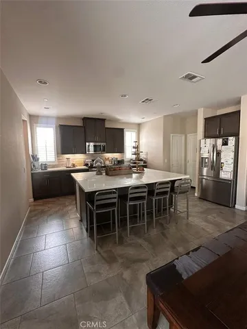 a kitchen with a dining table chairs and a counter top space