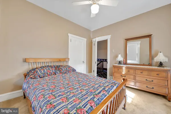 a bedroom with a bed and dresser