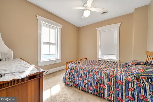 a bedroom with a bed dresser and a window