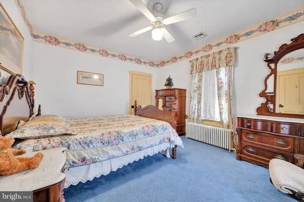 a bed room with a bed and a chair