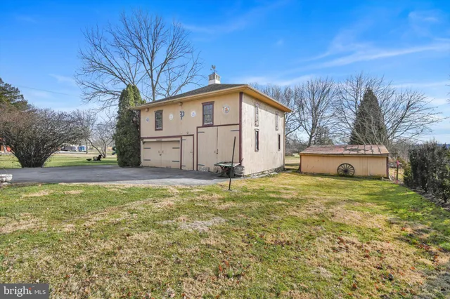 a white house that has a tree in front of it