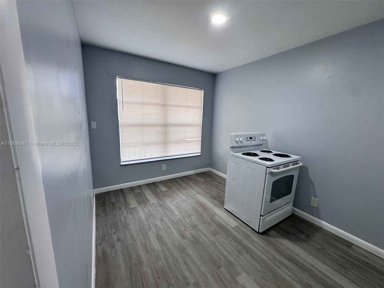 6840 Pembroke Road, Unit 118 Pembroke Pines, FL 33023 - Photo 3 of 7 a kitchen with a stove and a window