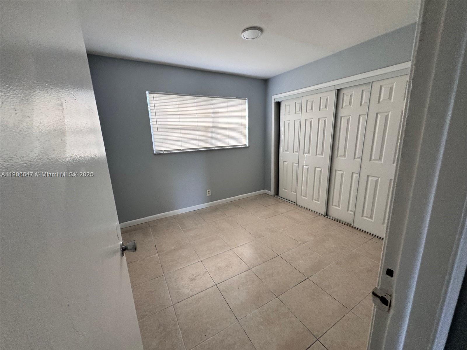 6840 Pembroke Road, Unit 118 Pembroke Pines, FL 33023 - Photo 6 of 7 a view of an empty room with a window