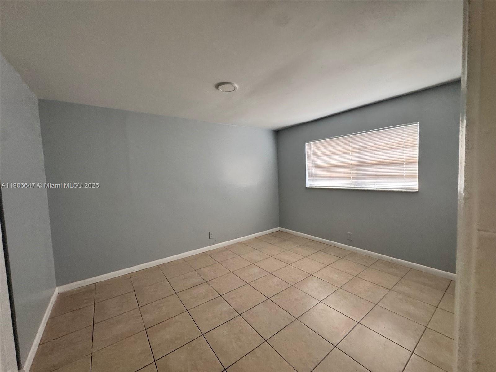 6840 Pembroke Road, Unit 118 Pembroke Pines, FL 33023 - Photo 7 of 7 a view of an empty room and window
