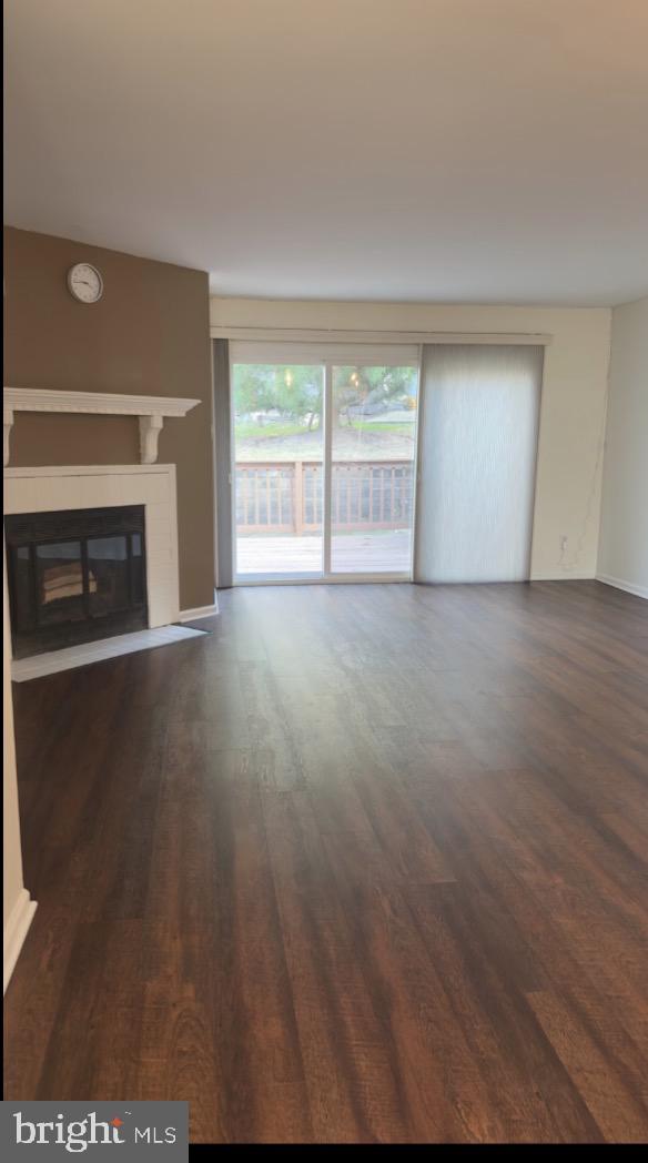 342 Brigade Court, Unit 342 Chesterbrook, PA 19087 - Photo 5 of 16 a view of empty room with wooden floor and fireplace