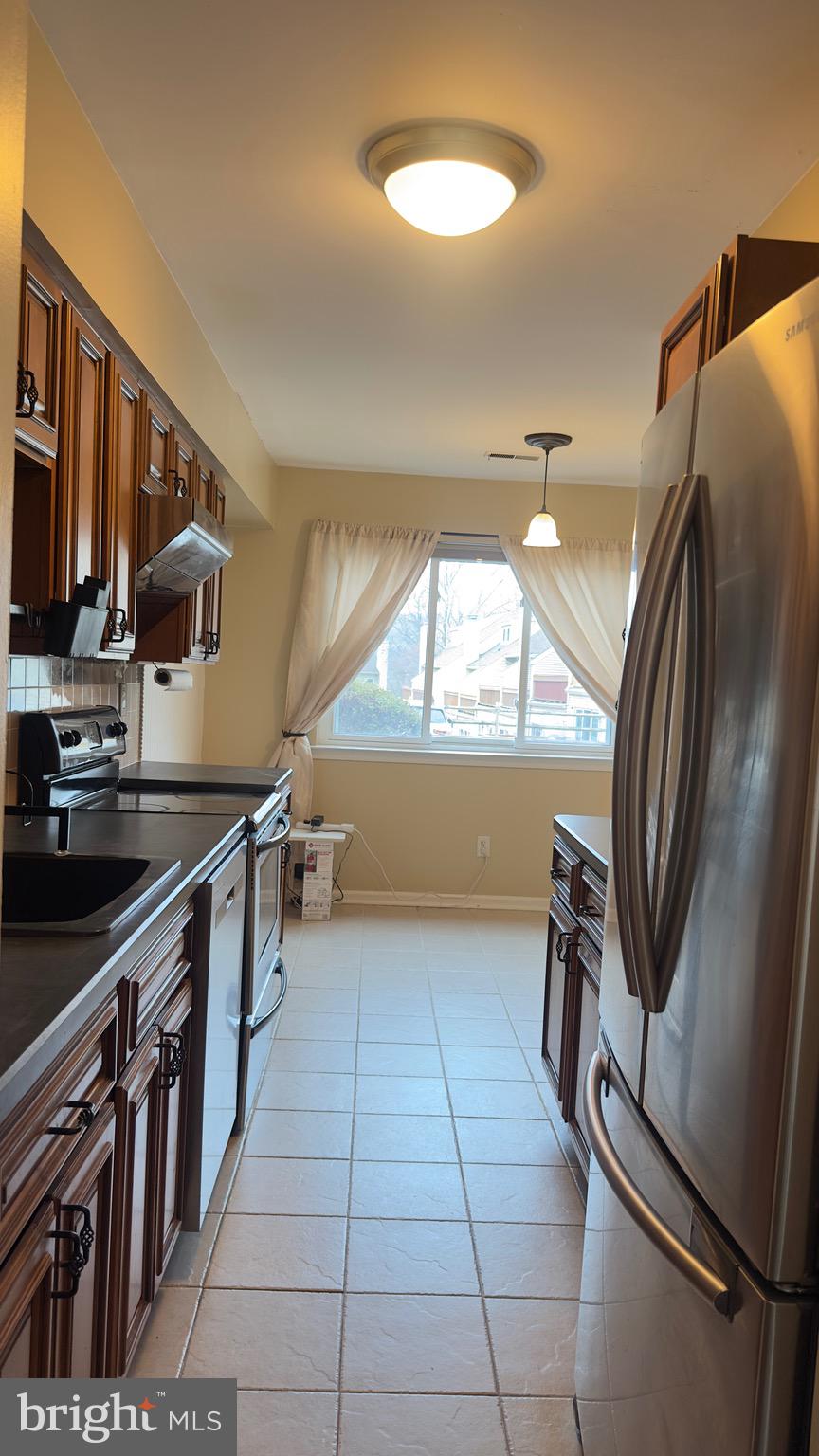 342 Brigade Court, Unit 342 Chesterbrook, PA 19087 - Photo 6 of 16 a kitchen with stainless steel appliances granite countertop a refrigerator and a sink