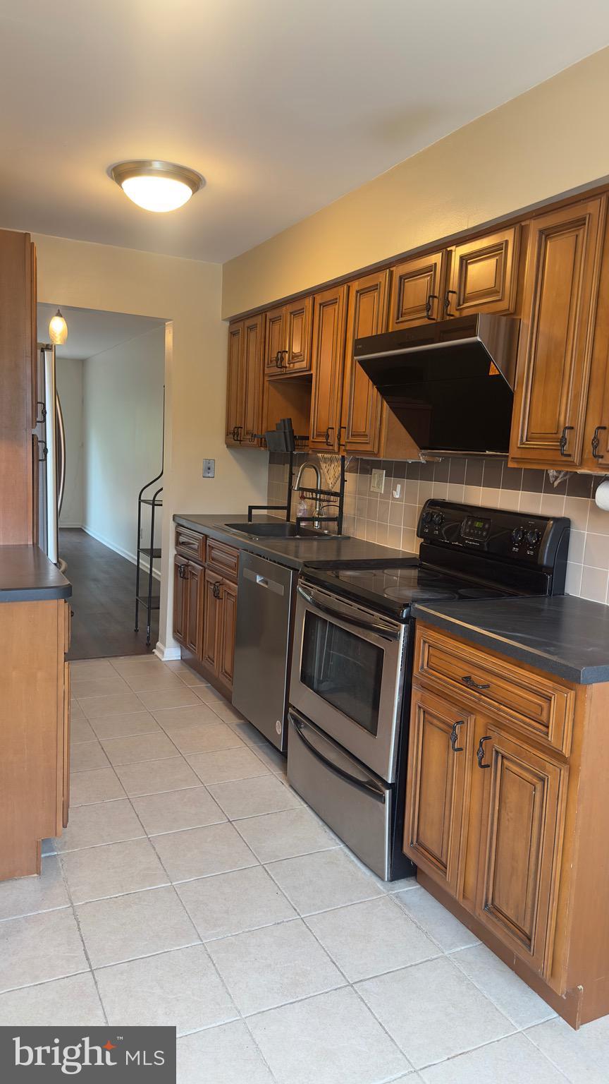 342 Brigade Court, Unit 342 Chesterbrook, PA 19087 - Photo 7 of 16 a kitchen with stainless steel appliances granite countertop a stove and a sink