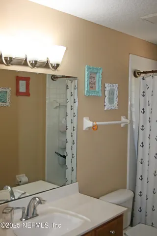 a bathroom with a shower toilet and sink