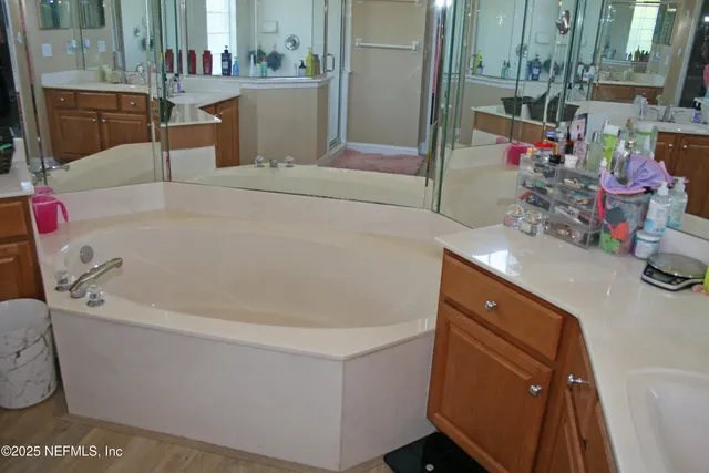 a bath tub sitting next to a bathroom sink