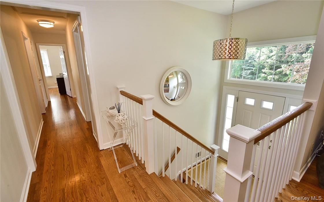 9 Franklin Avenue Rye, NY 10580 - Photo 6 of 35 a view of a hallway with wooden floor and a large mirror