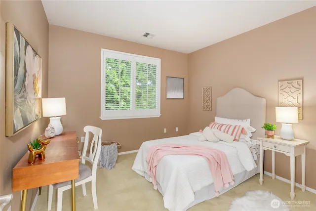 a bedroom with a bed and a chair