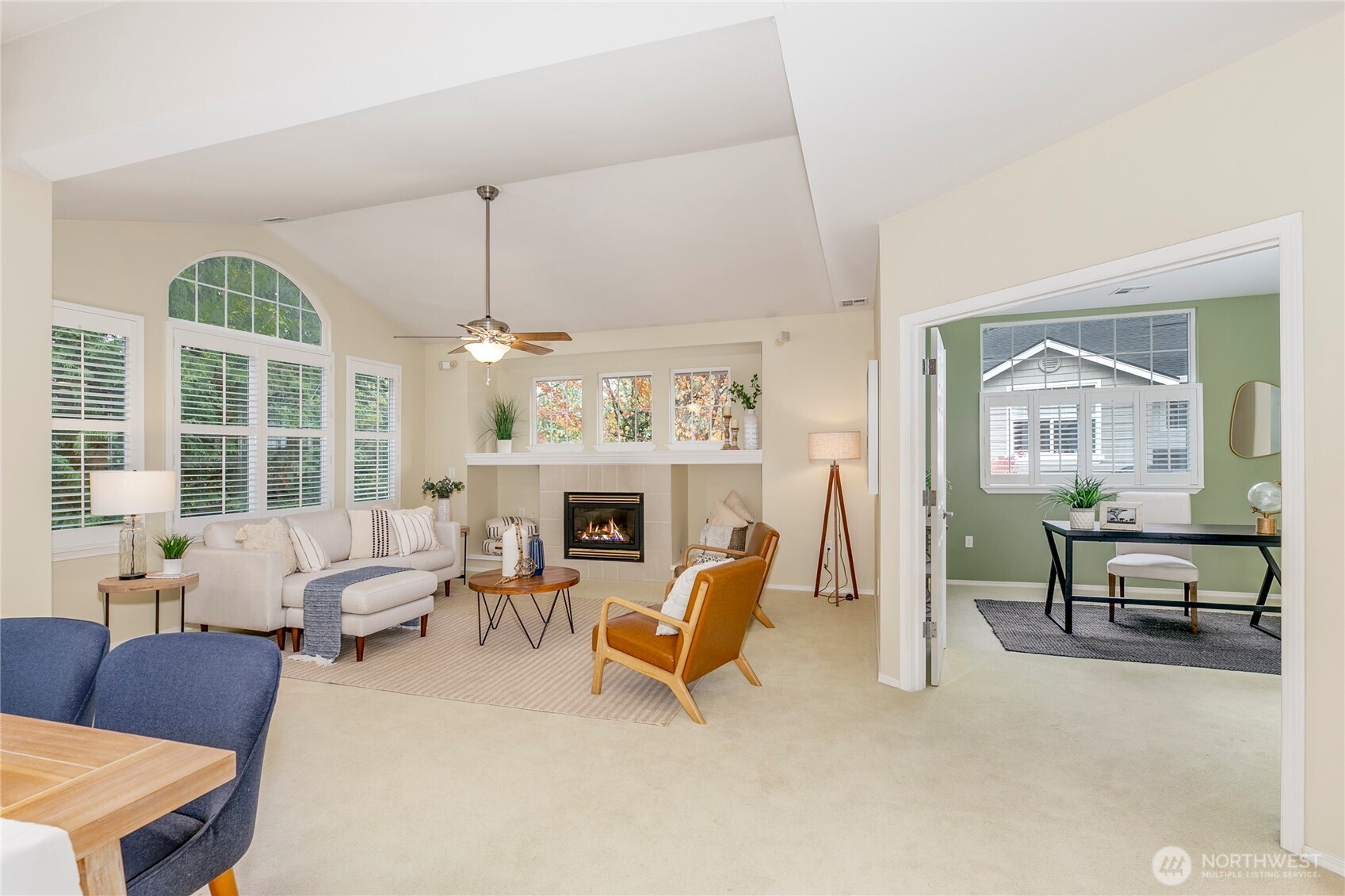5500 Harbour Pointe Boulevard, Unit B202 Mukilteo, WA 98275 - Photo 4 of 30 a living room with furniture a fireplace and a chandelier