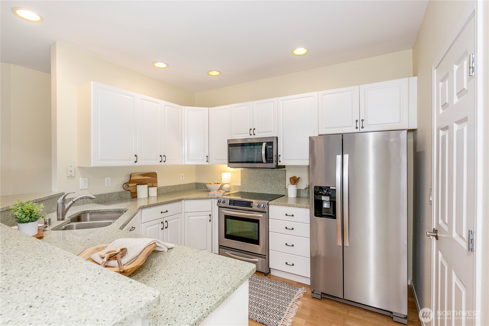5500 Harbour Pointe Boulevard, Unit B202 Mukilteo, WA 98275 - Photo 7 of 30 a kitchen with stainless steel appliances granite countertop a refrigerator sink and stove