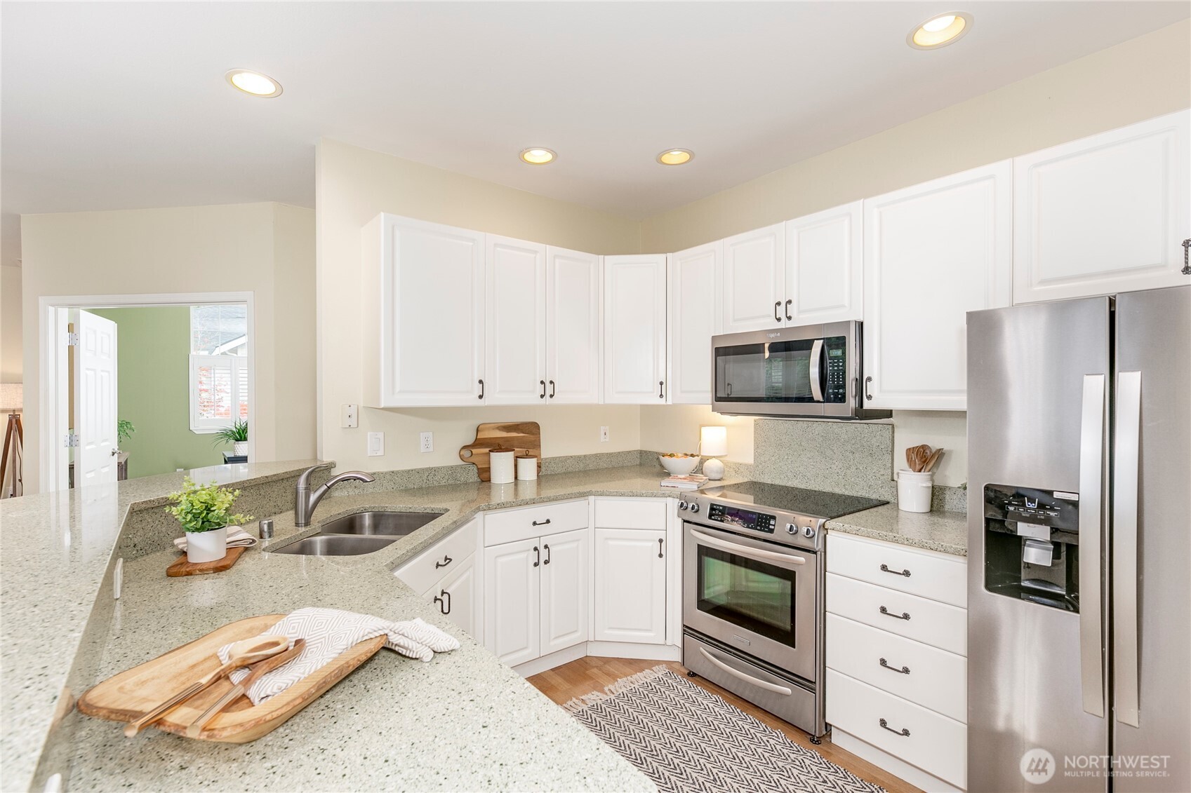 5500 Harbour Pointe Boulevard, Unit B202 Mukilteo, WA 98275 - Photo 8 of 30 a kitchen that has a sink and a stove top oven