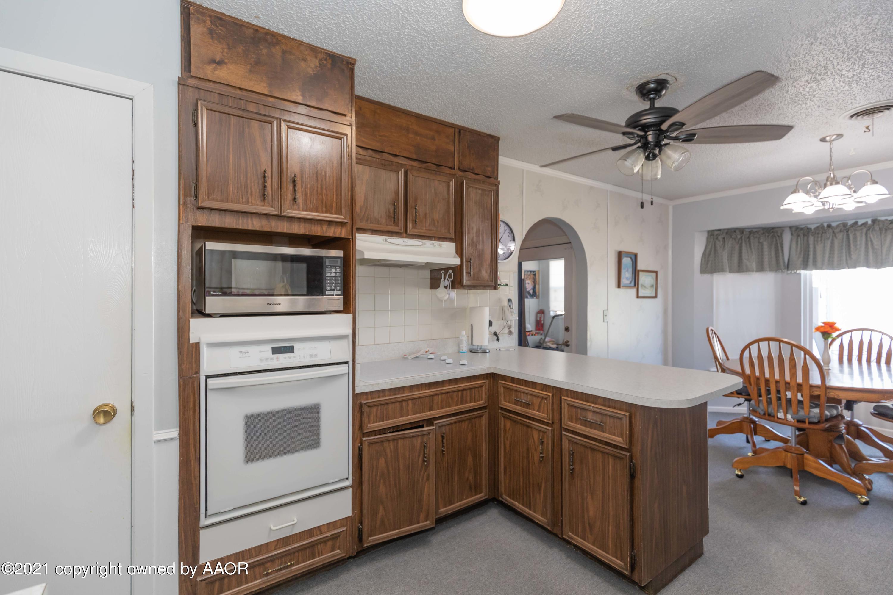 5104 McCarty Boulevard Amarillo, TX 79110 - Photo 11 of 35 a kitchen with a sink appliances and cabinets