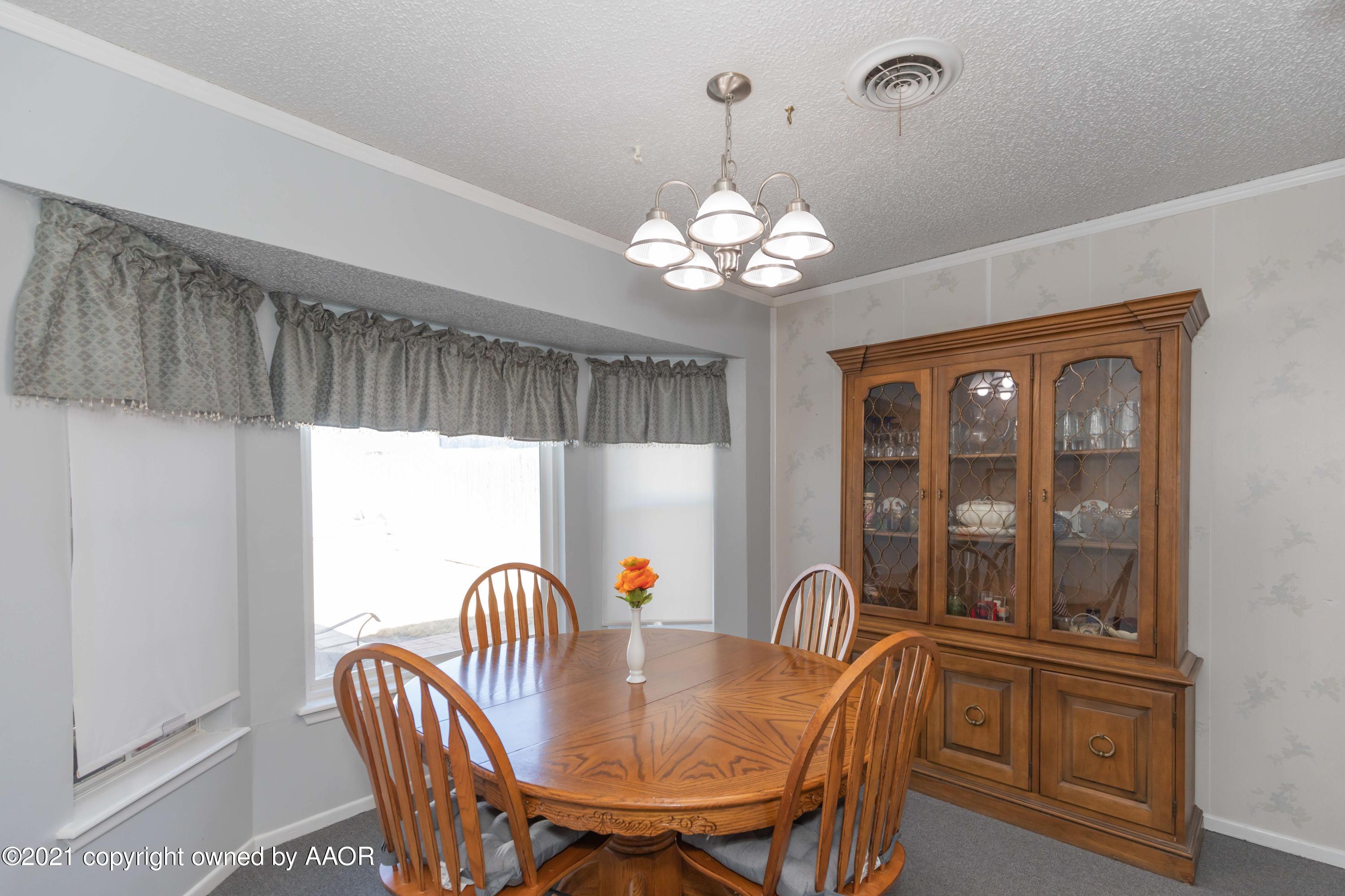 5104 McCarty Boulevard Amarillo, TX 79110 - Photo 12 of 35 a view of a dining room with furniture wooden floor and chandelier