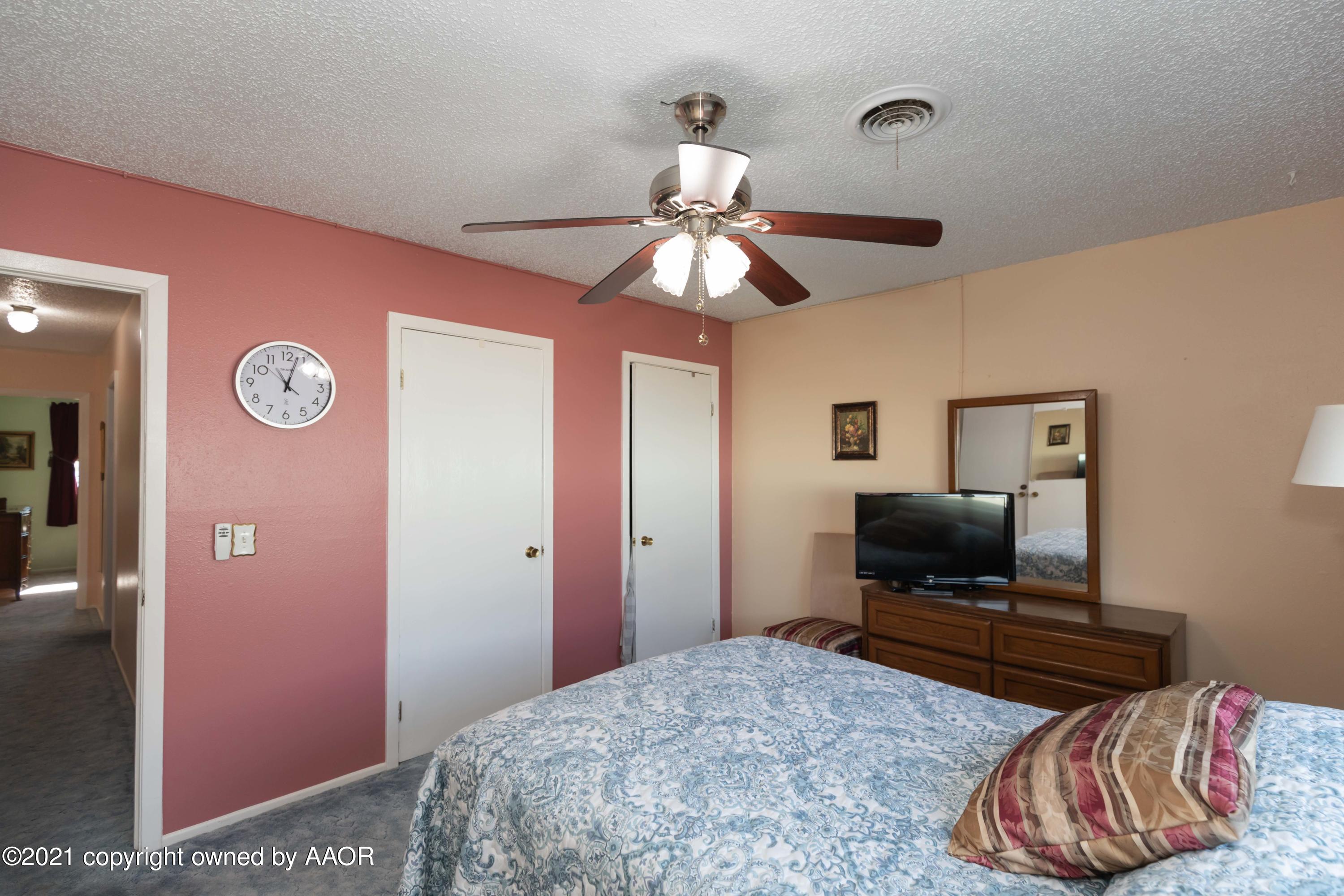 5104 McCarty Boulevard Amarillo, TX 79110 - Photo 15 of 35 a bedroom with a bed and a flat screen tv