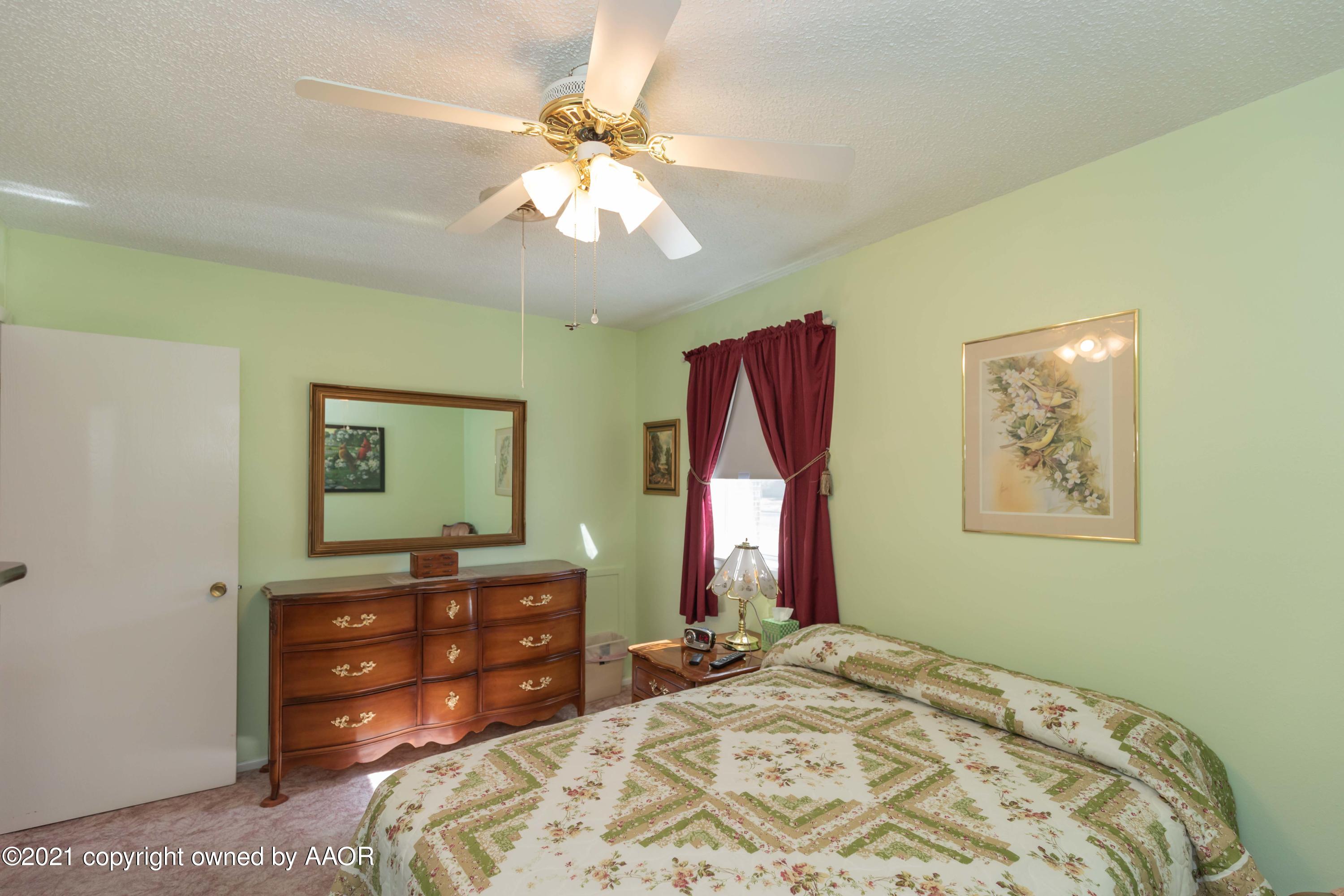 5104 McCarty Boulevard Amarillo, TX 79110 - Photo 20 of 35 a bedroom with a bed and a dresser